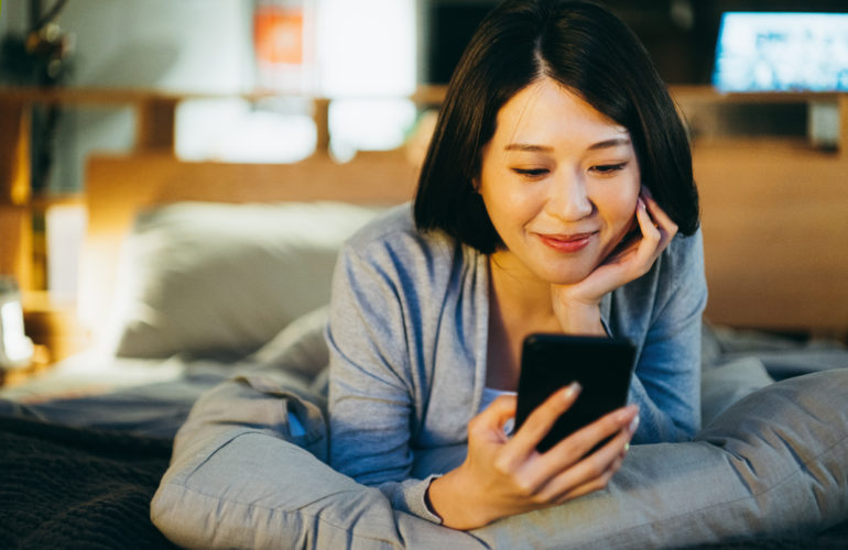 Smiling woman buing from an e-commerce in China